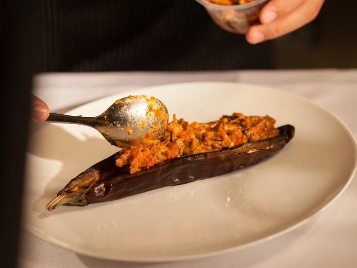 a chef putting the final touches to a food dish