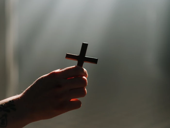 a person holding a cross