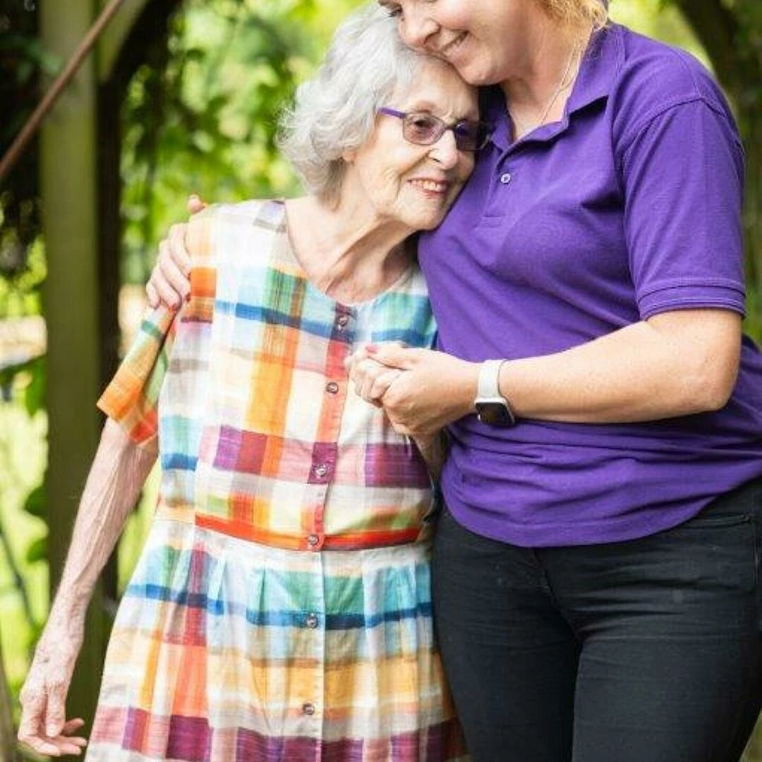 ann in her garden with carer jody roberts
