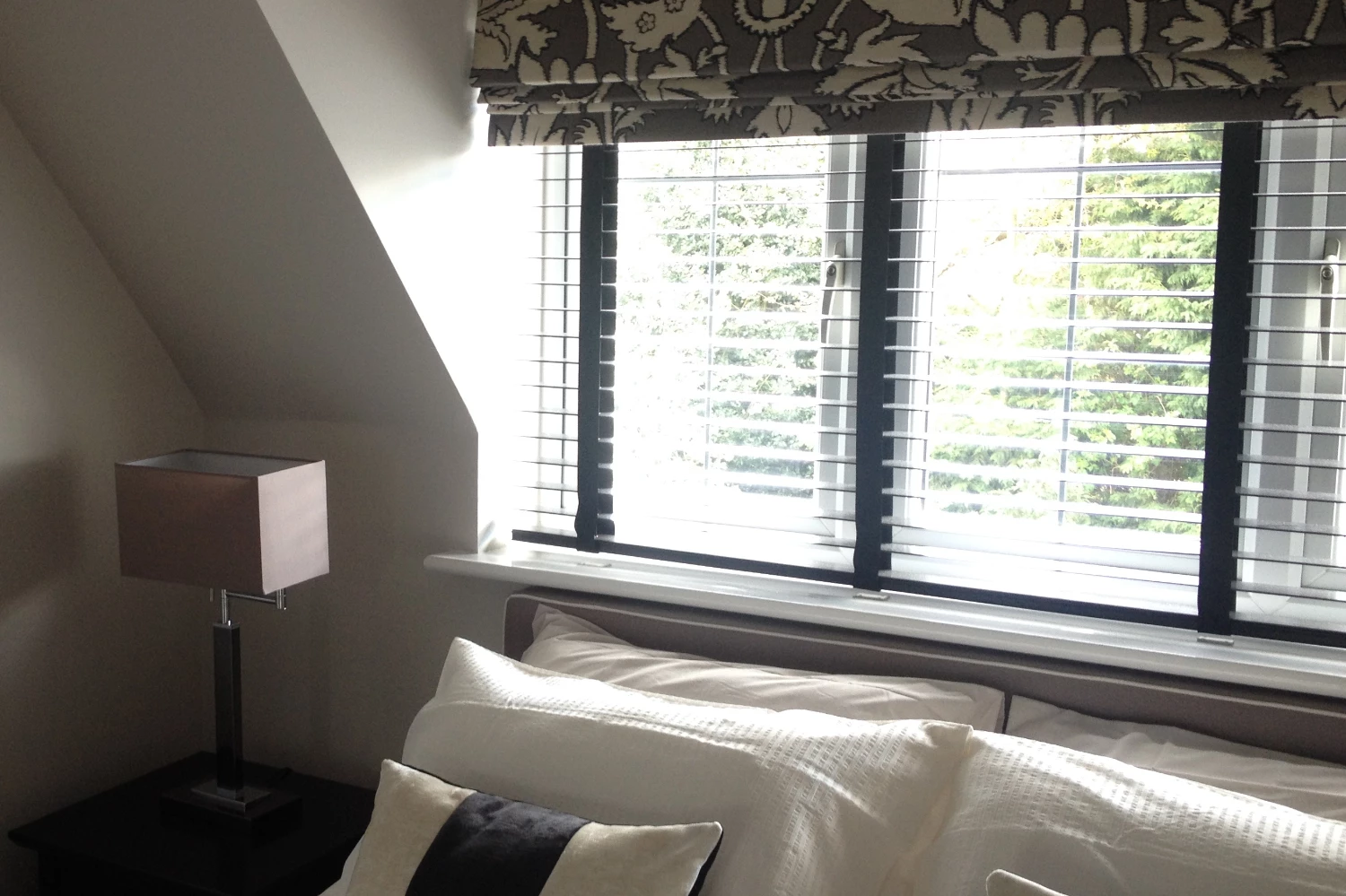 Venetian blinds with grey cushions