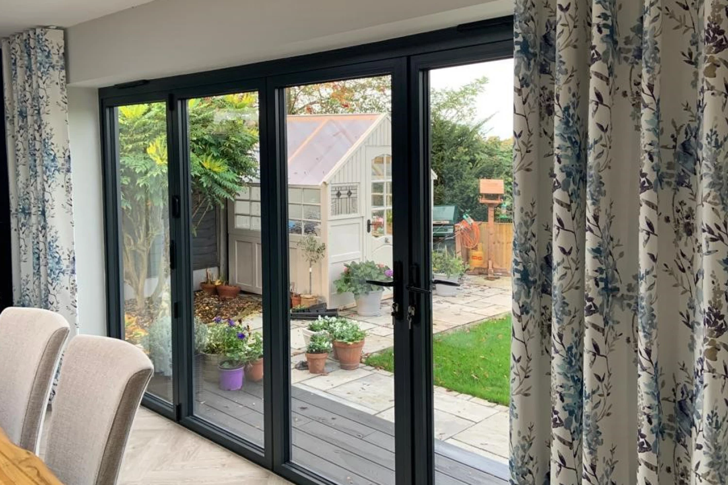 Wave heading curtains on bifold doors