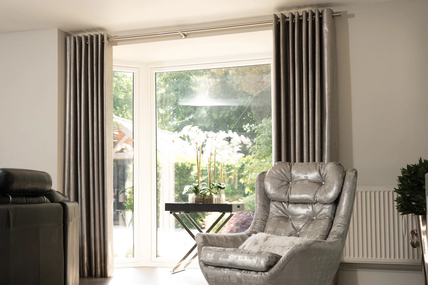 Eyelet curtains with grey chair