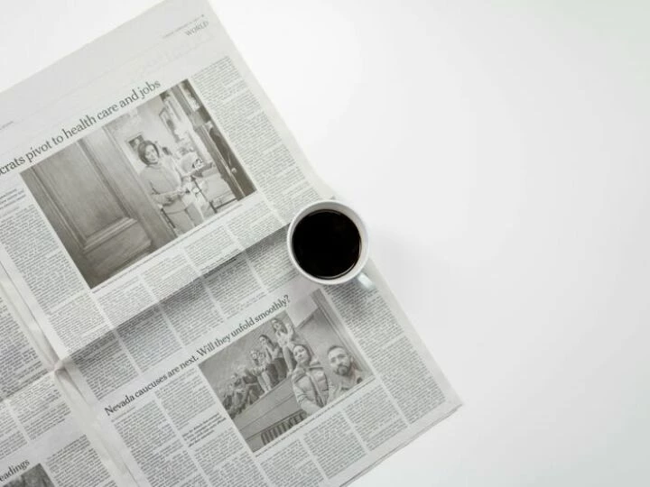 White Ceramic Mug On Top of a Newspaper