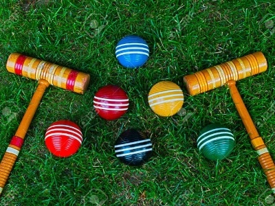 9700528-Croquet-mallets-and-balls-on-grass-background-Stock-Photo-croquet