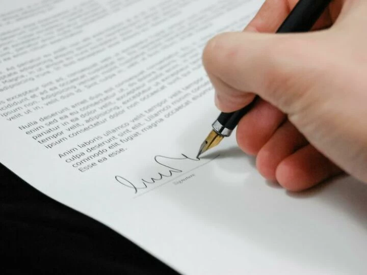 Person Signing in Documentation Paper