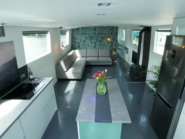 Interior of a solar-powered boat showing kitchen and dining area