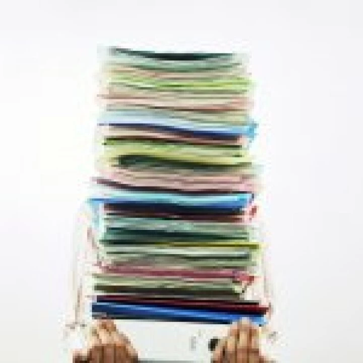 Businessman Carrying Pile of Files