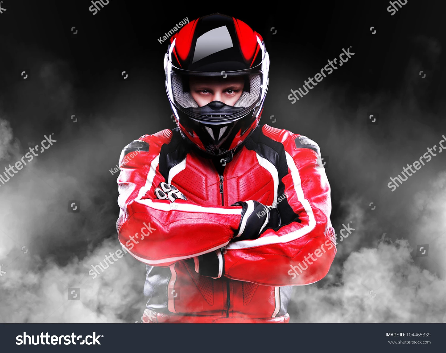 Stock photo motorcyclist standing in smoke on black background 104465339