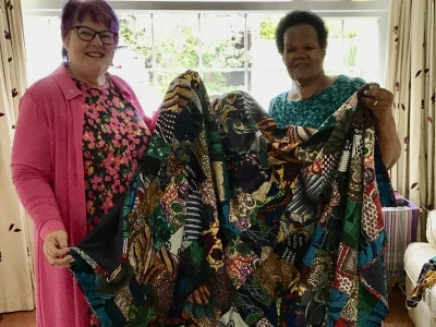 Sue Teal presenting a bed cover made from material from Africa by the Driffield Methodist Church Banner Group.