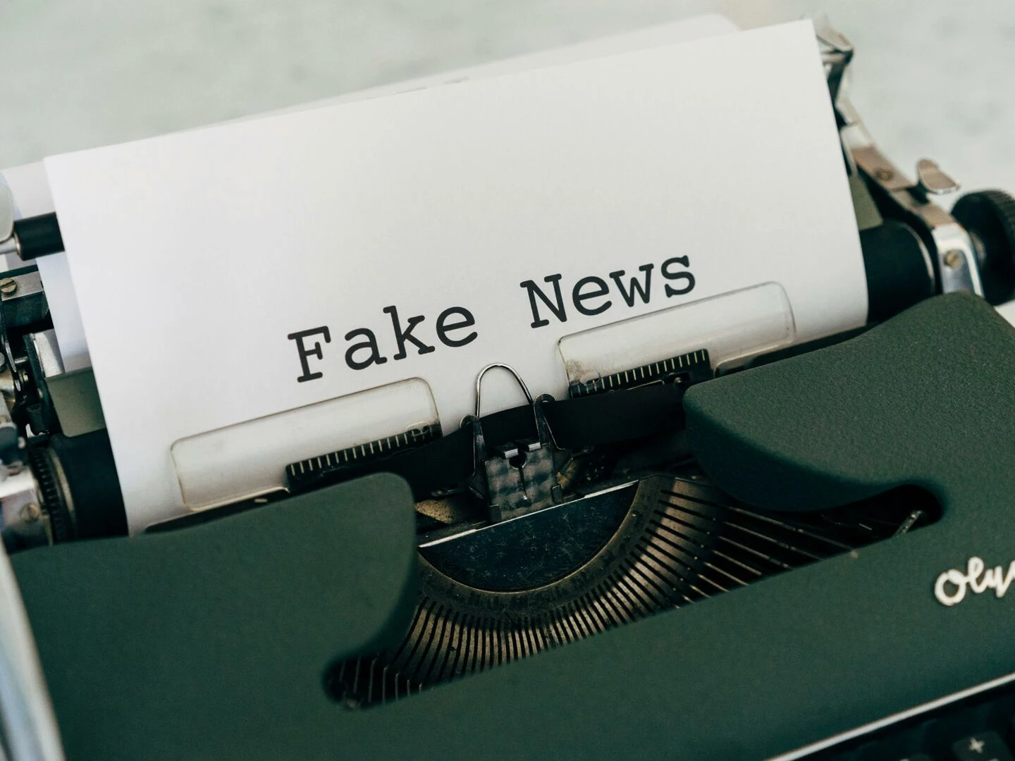 closeup of vintage typewriter printing 39fake news39 depicting false information concepts
