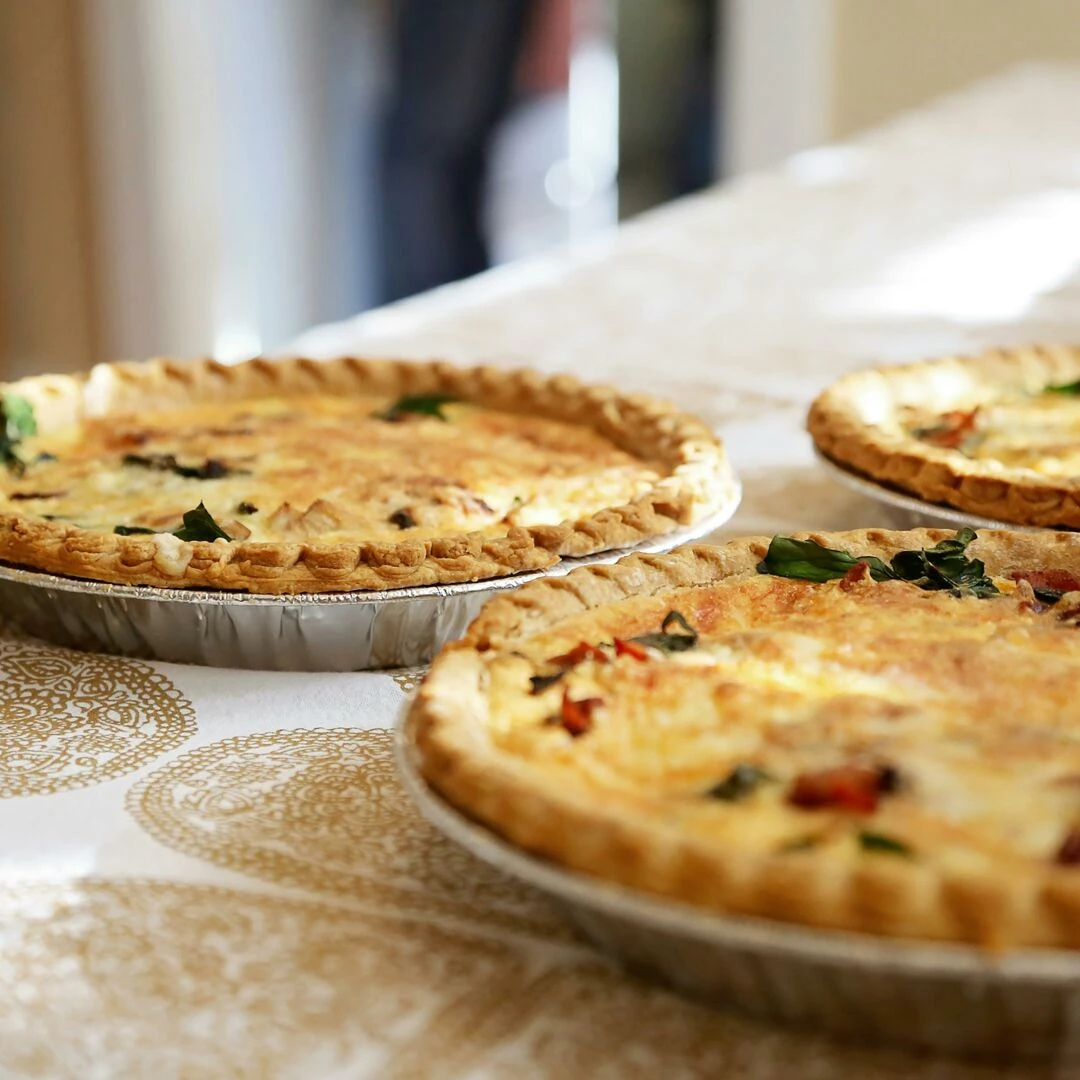 delightful homemade quiches on a classic patterned tablecloth inviting and delicious