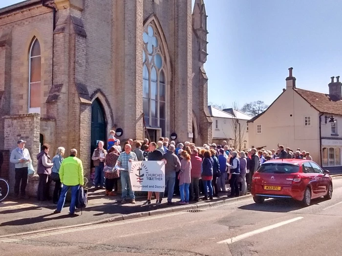 ecumenical walk of witness on good friday pauses outside trinity united church