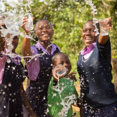 members of st balikddembe schools health club shc enjoying the new water source  copyright all we can