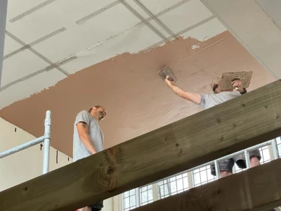 plastering the ceiling above the choir stalls