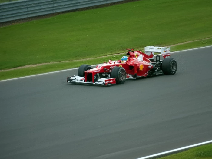 red ferrari on a racetrack