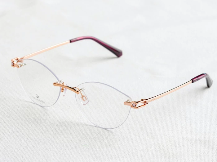 rimless glasses on white fabric