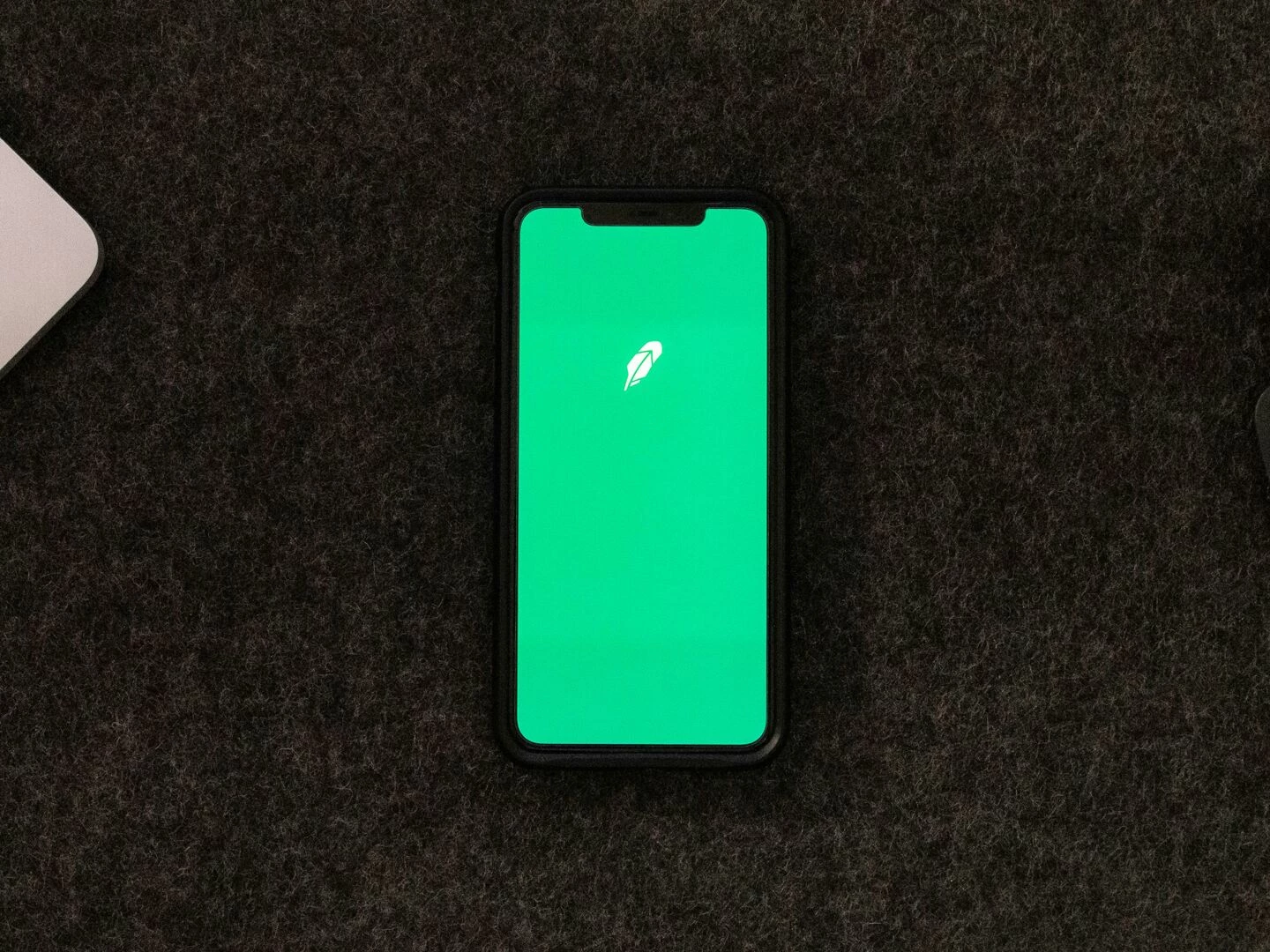 smartphone displaying trading app on a desk for stock finance concepts
