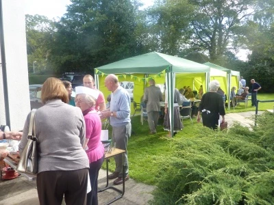 visitors enjoying tea and cake in the sunshine