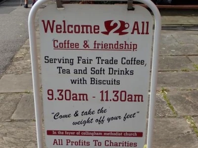welcome  2 all cafe street sign