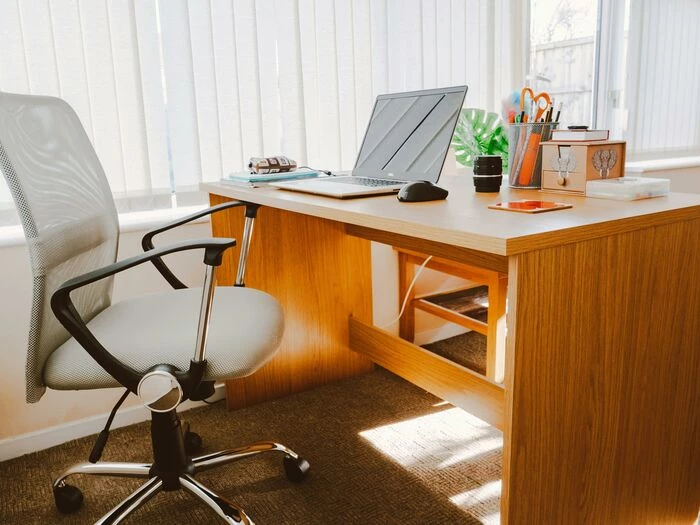 white rolling armchair beside table