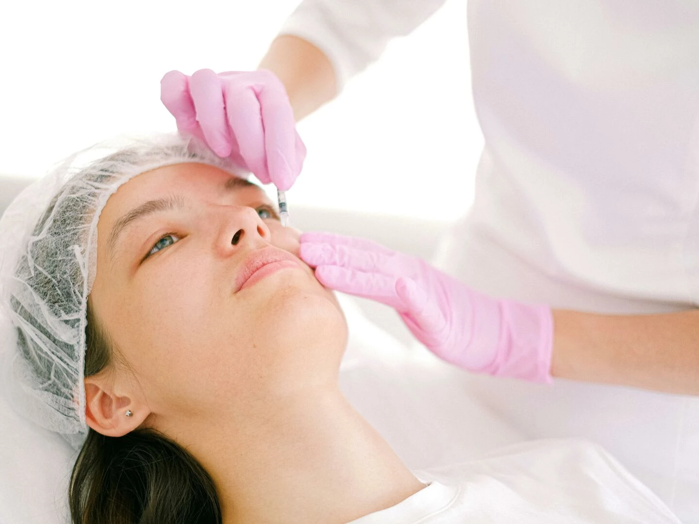 woman receives cosmetic injection in clinical setting enhancing beauty using modern techniques