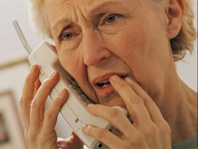 worried senior person on phone